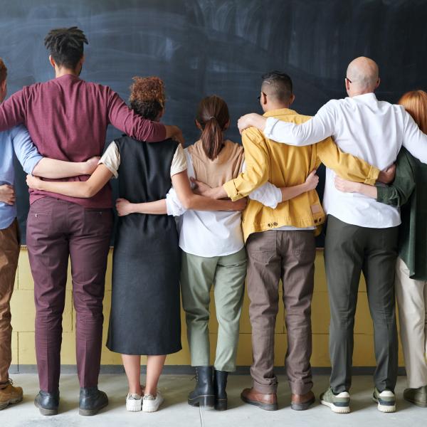 a line of people linking from behind