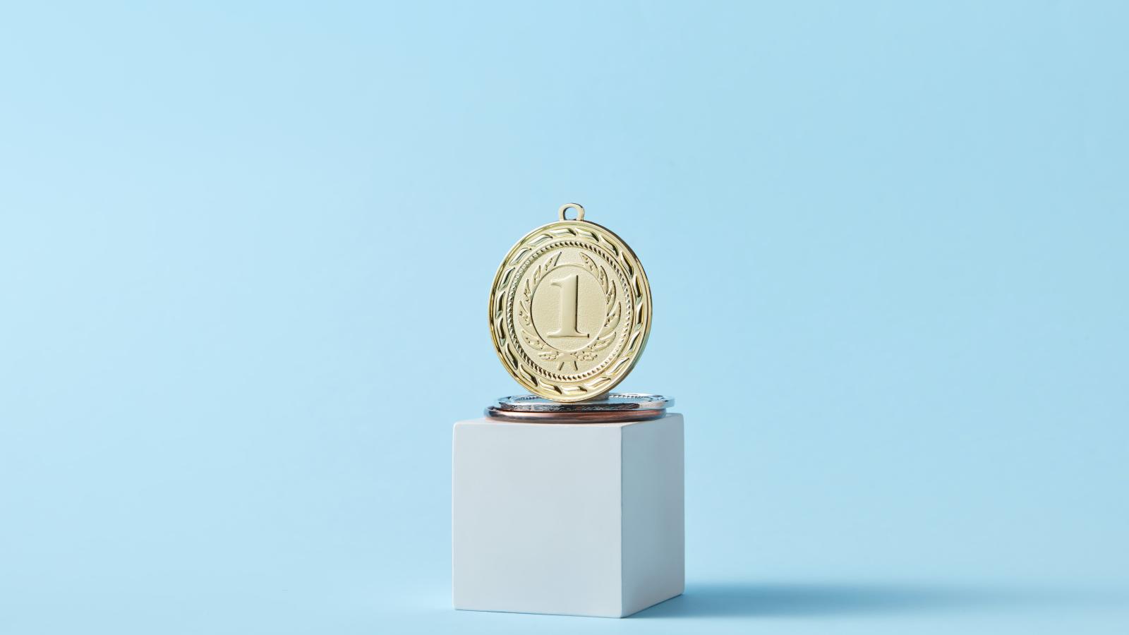 Gold medal on blue background