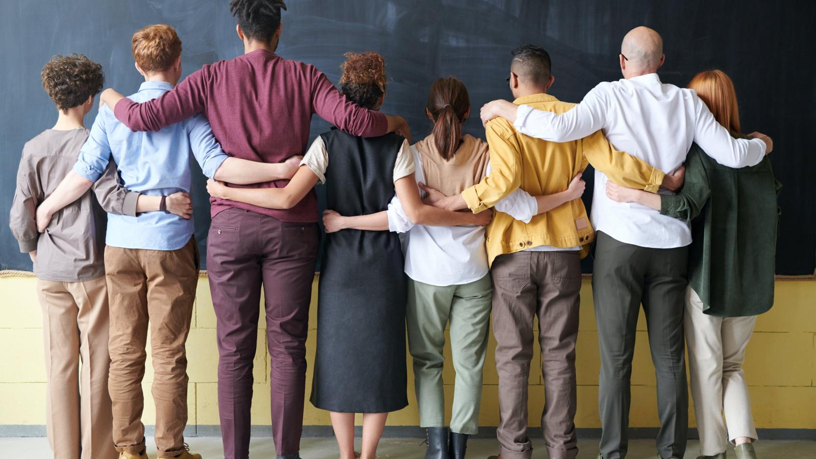 a line of people linking from behind